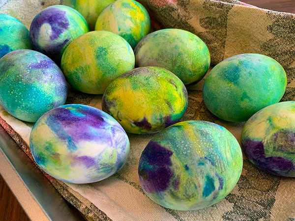 easter eggs decorated using whipped topping and food color